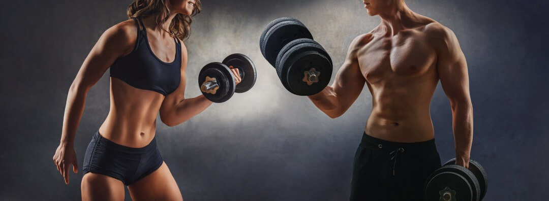 smiling woman an man with dumbbell – successful fitness studio concept